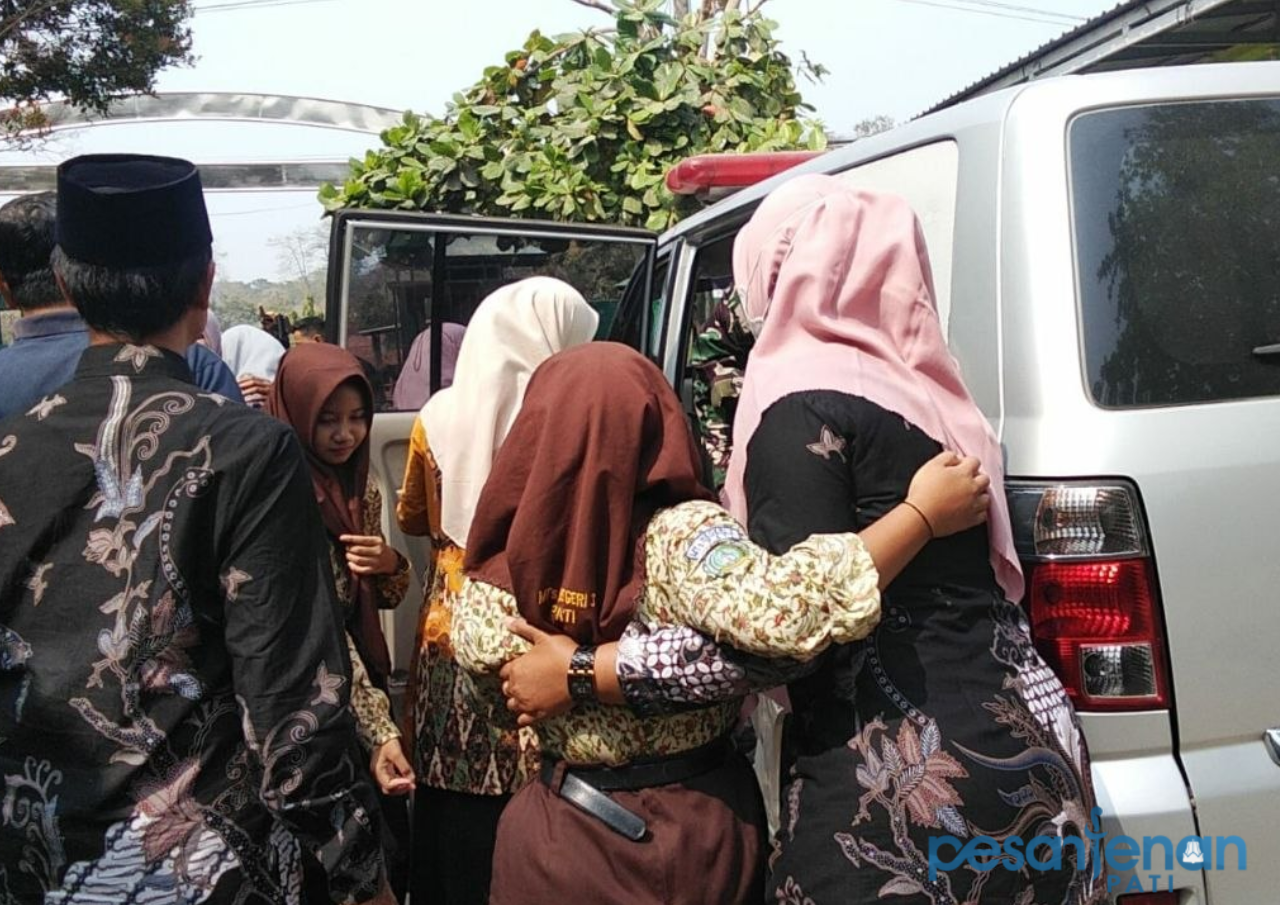 Foto: Seorang siswa di MTs N 3 Pati dinaikin ke mobil ambulan untuk dibawa ke RSUD Soewondo Pati. (Sumber. Mitrapost.com) Distribusi Terlambat, Ratusan Siswa MTsN 3 Pati dan SMPN 1 Gembong Diduga Keracunan MBG